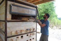 a man is working on an oven outside