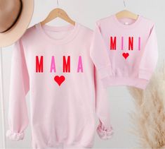 Mama or Mini printed on a crewneck sweatshirt.  This design is perfect to match for Valentine's Day! No returns or exchanges on customized items. Please contact me at any time for concerns about your purchase. Care instructions: Turn inside out and wash on cold. Tumble dry on low. Mother's Day Graphic Print Crew Neck Sweatshirt, Family Matching Letter Print Sweatshirt As Gift, Family Matching Sweatshirt With Letter Print As Gift, Family Matching Sweatshirt With Letter Print, Mother's Day Family Matching Crew Neck Sweatshirt, Mother's Day Sweatshirt With Name Print And Crew Neck, Customizable Family Matching Crew Neck Sweatshirt, Mother's Day Custom Print Crew Neck Sweatshirt, Family Matching Crew Neck Sweatshirt For Mother's Day