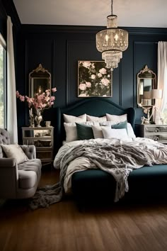 a bedroom with dark blue walls, white bedding and chandelier hanging from the ceiling