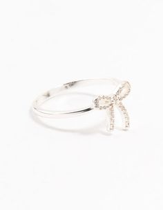 Elevate your signature style with stunning sterling silver pieces. This flirty bow motif ring, adorned with cubic zirconia crystals, crafted from genuine 925 sterling silver, ensures durability and chic sophistication. Material: Crystal, Cubic Zirconia, Sterling Silver Dimensions: Diameter 17 mm x Band Width 1 mm | Lovisa Sterling Silver Cubic Zirconia Bow Ring, Size: XS/S, Clear Bow Ring, Silver Pieces, Signature Style, Fashion Rings, Cubic Zirconia, Ring Size, 925 Sterling Silver, Band, Sterling Silver