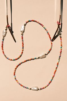 Brighten your day with this colorful and modern beaded AirPods and glasses lanyard! Handcrafted with a vibrant mix of glass beads and elegant pearl-inspired accents, this lanyard is the perfect fusion of function and fashion. Its bold design keeps your everyday essentials close while elevating your style. Multifunctional Design: Seamlessly switch between using it as an AirPods holder or an eyeglass chain. Eye-Catching Colors: A playful palette of red, pink, turquoise, yellow, and more brings energy to your look. Handcrafted Quality: Made with premium materials and designed for long-lasting wear. Lightweight and Comfortable: Ideal for everyday use without feeling bulky or heavy. Secure Fit: Comes with silicone loops and clasps to keep your items safe and in place. Chains Aesthetic, Glasses Lanyard, Playful Palette, Sun Glass, Sunglasses Chain, Glasses Chains, Sunglass Holder, Glass Holder, Eyeglass Chain