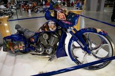 a blue motorcycle on display in a building