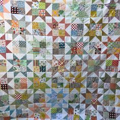 a quilt made with many different colored blocks and squares on the front, side, and back