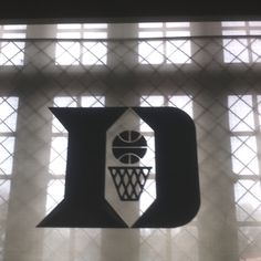 the letter d is made up of black and white paper with a basketball on it