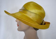 A vintage 1980s saffron yellow woven straw cloche style sun hat with an antique gold wide ribbon band and a pale copper silk rose with metallic gold edges.  The hat was made in USA by Plaza  suite by Betmar.  The hat has a 1/2 inch rip at the back of the crown and a 1 inch green mark on the inner band.  The brim is 4 inches wide at the front, the crown is 4 inches tall, 7 inches front to back and 6 inches side to side measured across the top, 24 inches around the inner gros grain band.  7 oz., boxed Please also follow me on Instagram at ChrisMartinDesigns Gold Brimmed Straw Hat, Gold Wide-brim Straw Hat For Kentucky Derby, Gold Wide Brim Straw Hat For Kentucky Derby, Gold Brimmed Straw Hat For Kentucky Derby, Gold Fedora Straw Hat For Kentucky Derby, Gold Curved Brim Hat For Kentucky Derby, Gold Fedora For Kentucky Derby, Adjustable Gold Straw Hat For Kentucky Derby, Gold Straw Hat With Short Brim For Party