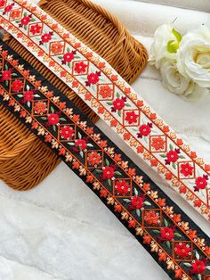 three different types of beaded trims sitting on top of a basket next to flowers