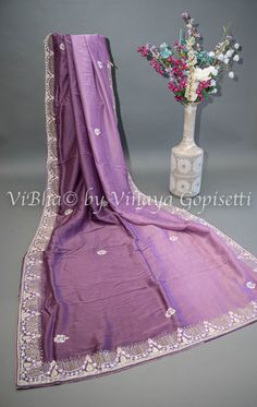 This dark mauve saree and blouse set is elegantly embroidered with stones and crystals, adding a touch of glamour to your look. Made from soft and easy to drape organza fabric, it offers comfort and effortless style. Perfect for special occasions and wedding events. Elegant Purple Tissue Silk Pre-draped Saree, Unstitched Purple Pre-draped Saree With Dori Work, Elegant Purple Chanderi Pre-draped Saree, Purple Silk Dupatta For Reception, Purple Georgette Saree With Dori Work, Elegant Purple Georgette Embroidered Fabric, Elegant Purple Embroidered Georgette Fabric, Purple Chikankari Traditional Wear For Reception, Elegant Semi-stitched Purple Embroidered Fabric