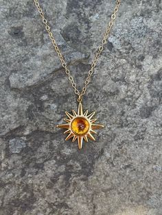 This necklace is handmade with a 19mm by 21mm 14k gold-plated stainless steel pendant and a 6mm genuine citrine cabochon. The chain is 14k gold-filled and will not tarnish.  This necklace is hypoallergenic. (Cadium free, lead free, and nickel safe) Citrine is a stone that promotes positive energy, abundance, and strength. Please note that each stone is unique and varies in color. The necklace comes in a ribbon-tied gift box and if you would like to leave a note, you can do so during checkout. 14k Gold Necklaces With Sun Design, Spiritual Yellow Gold Jewelry With Sun Design, Spiritual Gold Jewelry With Sun Design, Gold Celestial Sunburst Jewelry, Gold Brass Jewelry With Sun Design, Sun-shaped Jewelry With Sun And Moon Design For Gift, Gold Jewelry With Sun Design In Brass, Handmade 14k Gold Amber Jewelry, Gold Jewelry With Sun Design In 14k Gold