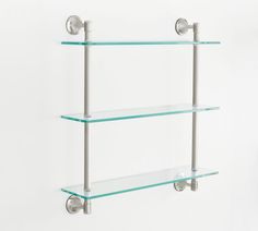 three glass shelves with metal handles on each shelf