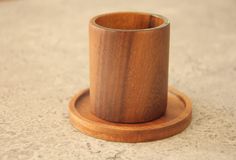 a wooden cup holder sitting on top of a counter