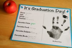 an apple and handprints on a table with the words it's graduation day