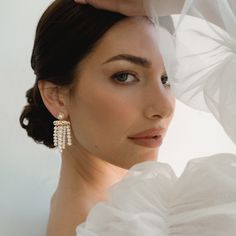 Introducing our Sienna Earrings with Pearl Fringe, the perfect complement for our free-spirited bride on her special day. These stunning earrings are meticulously handcrafted in our Dallas-based studio and feature a delicate arrangement of lustrous freshwater pearls. The lightweight design allows for effortless movement, letting the pearl fringes dance with every step you take down the aisle. Gold plate over brass Freshwater pearls Nickel- and lead-free Elegant Pearl Dangle Chandelier Earrings, Elegant Pearl White Dangle Chandelier Earrings, Elegant Pearl Chandelier Dangle Earrings, Elegant Pearl Chandelier Earrings, Elegant Pearl White Pearl Chandelier Earrings, Elegant Pearl Bridal Earrings With Pearl Chain, Elegant Pearl Chain Bridal Earrings, Graceful Pearl Dangle Earrings, Graceful Pearl White Pearl Earrings