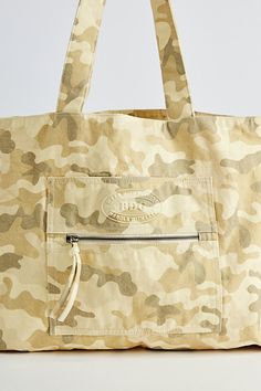 Large size tote bag by BDG & only at UO. Washed cotton bag with a spacious main compartment and a zip pocket at the front. Includes twin carry handles. Features BDG large tote bag Classic shoulder bag Washed cotton Outer zip pocket Carry handles Content + Care 100% Cotton Spot clean Imported | BDG Large Tote Bag in Camo at Urban Outfitters Cotton Beach Bag With Pockets For Everyday Use, Cotton Beach Bag With Pockets For Travel, Canvas Tote Beach Bag With Pockets, Cotton Canvas Bag With Zipper For Shopping, Cotton Tote Weekender Bag With Pockets, Cotton Canvas Bag With Pockets For Shopping, Cotton Beach Bag With Pockets, Cotton Canvas Bag With Zipper Closure For Shopping, Large Capacity Cotton Tote Weekender Bag