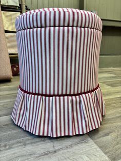 a red and white striped hat on the floor