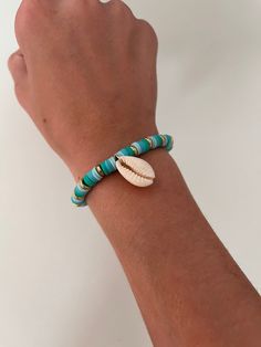 It is one of my favorite summer bracelets. It's perfect for the beach and will hold all year long. It has three shades of this beautiful blue, it also includes a gold embellishment, and a shell. Gold Strand Beaded Bracelets For Vacation, Turquoise Bracelet Jewelry For Beach, Turquoise Bracelets For The Beach, Gold Beaded Ocean-inspired Bracelets For Vacation, Ocean-inspired Gold Beaded Bracelets For Vacation, Gold Ocean-inspired Beaded Bracelets For Vacation, Blue Bracelet For Vacation, Blue Bracelet Jewelry For Beach Season, Blue Beachy Shell For Vacation