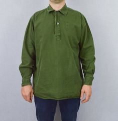 "True vintage Swedish military smock tops from the 1960s-80s, made from a soft cotton with grandad style button down neckline, button cuffs and curved hem. We only have a very small batch of these with no chance of re stock right now, so quantities are limited. - Soft worn in cotton - Loose, comfy fit - Dip hem design - True vintage from the Swedish army - Fabric is 100% cotton SIZING XS - fits chest 34\" Small - fits chest 36\", Medium - fits chest 38\"-40\", Large - fits chest 42\"-44\" XL - f Vintage Style Solid Color Top With Button Closure, Vintage Style Solid Top With Button Closure, Vintage Relaxed Fit Tops With Buttons, Khaki Cotton Tops With Buttons, Cotton Khaki Tops With Placket, Vintage Collared Cotton Tops, Vintage Long Sleeve Tops With Pockets, Retro Top With Buttons, Vintage Long Sleeve Tops With Buttons