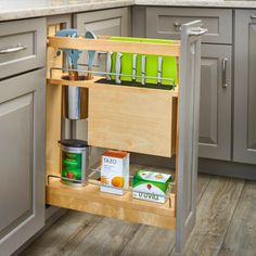 an open cabinet in a kitchen with utensils and other items on the shelves