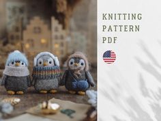 three little knitted owls sitting on top of a wooden table next to each other