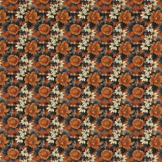 an orange and black floral pattern on fabric with white flowers in the center, as well as