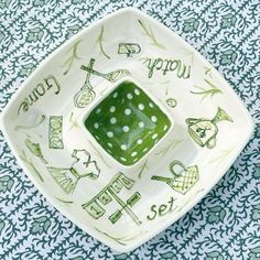 a green and white dice bowl with happy new year written on it