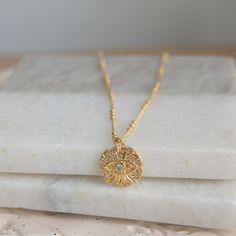 This stunning gold Evil Eye necklace is more than just an accessory--it's a powerful symbol of protection and good fortune. Crafted with an 18K gold-plated pendant and encrusted with sparkling cubic zirconia, this necklace is the perfect mix of elegance and meaning, designed to elevate your everyday style or serve as a thoughtful gift for someone special. 🌸 Details: Material: 18K Gold-Plated Brass Gemstones: Clear Cubic Zirconia Chain Length: 16 inch + 1-inch extender Pendant Size: 15 mm diameter 🌸 Why You'll Love It: This Evil Eye necklace offers both style and substance, combining timeless design with a protective symbol that's perfect for everyday wear. The gold-plated pendant and cubic zirconia accents catch the light beautifully, making this piece both eye-catching and versatile. 🌸 Spiritual 14k Gold Coin Necklace, Gold Tarnish Resistant Pendant Charm Necklace, Gold Tarnish-resistant Pendant Charm Necklace, Symbolic Good Luck Coin Pendant Necklace, Spiritual Good Luck Necklace With Round Shape, Good Luck Spiritual Necklace With Round Shape, Spiritual Round Good Luck Necklaces, Spiritual Good Luck Round Necklace, Gold-tone Amulet Necklace With Round Pendant