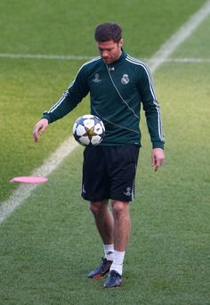 a man holding a soccer ball on top of a field