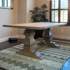 a dining room table in the middle of a living room