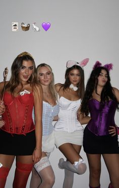 four women dressed in costumes posing for a photo