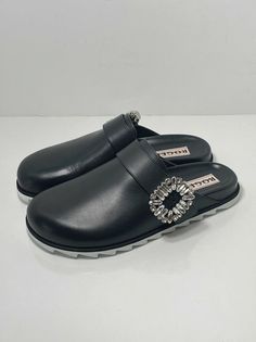 Roger Vivier Slidy Crystal-buckled Leather Backless Loafers size 37. New never worn with box and dust bag. Size 37, fits us size 7 Fainted scratches on the right shoe from handling. 100% Authentic guaranteed Retail for $1200 Made from polished black leather, they're embellished with signature crystal strass buckles for a bit of glamour, while ergonomic footbeds and shark-tooth soles lend them practicality. upper: leather lining: leather sole: leather insole, rubber sole round toe Made in Italy Line cross the label as final sale Luxury Closed Toe Clogs With Rubber Sole, Backless Loafers, Shark Tooth, Roger Vivier, Shark Teeth, Gucci Mules, Flat Shoes Women, The Label, Mule Shoe