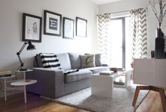 a living room filled with furniture and pictures on the wall