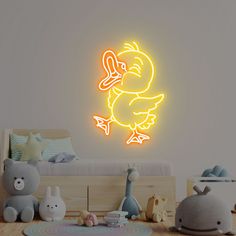 a neon yellow duck with an arrow in its beak on a wall next to a child's bed