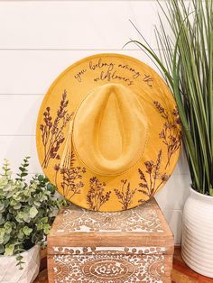 Wildflower Burned Hat, Floral Engraved Cowboy Hat, Sunflower Hat, Sunflower Burned Fedora, Engraved Suede Hat, Boho Hat, Vegan Suede Elevate your style with our beautifully engraved floral hats! Choose from a variety of different hat colors. Band may shift or fall off during shipping. The hat has an adjustable band on the inside to fit many sizes. One size fits most adult heads. If you are looking for a custom order, please message us! Bride Cowgirl Hat With Aunflowers, Cow Print Burned Hat, Yellow Bohemian Fedora Hat, Bohemian Yellow Brimmed Hat, Yellow Bohemian Hat With Flat Brim, Yellow Bohemian Brimmed Hat, Burning Hats, Cowboy Hat Crafts, Burned Hats