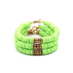 A lime green heishi bead bracelet is the perfect on-trend accessory to top off your look. It is a great stand alone bracelet and works well as a stack bracelet, too. This non-stretch bracelet features lime green polymer clay heishi beads with gold brushed metal beads in the center, all hand-strung onto flexible jewelry wire. The bracelet is finished off with a lobster clasp, and a 1" extender chain to accommodate various wrist sizes. MATERIALS Polymer Clay & Metal Beads SIZE 6 1/2" Extendable Up Green Heishi Beads Summer Jewelry, Summer Green Heishi Beads Jewelry, Green Bohemian Heishi Beads Stretch Bracelet, Trendy Green Stretch Bracelet Stackable, Trendy Green Stackable Stretch Bracelet, Green Heishi Beads Bracelets For Beach, Green Heishi Beads Bracelets For Summer, Green Heishi Beads Jewelry For Beach, Green Bracelets For Beach Spring Season