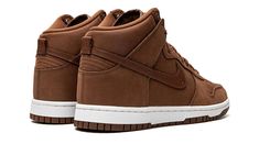 The Women’s Nike Dunk High Premium “Pecan” is a women’s-exclusive colorway of the popular sneaker with a mostly brown design.  A versatile, casual look for the Dunk High, the “Pecan” colorway features a monochromatic burnt orange upper with tonal overlays and Swoosh branding.  A debossed “Nike” logo is found on the tongue along with a classic Swoosh emblem.  Underfoot, a white rubber midsole and Pecan-colored rubber outsole finish off the look.  Release date: October 12, 2022 Nike Dunk High Premium, Brown Design, Popular Sneakers, Nike Dunk High, Dunk High, Stadium Goods, Nike Dunk, Nike Dunks, Nike Logo