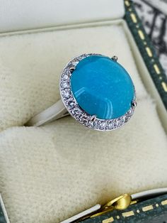 a blue ring sitting in a box on top of a table