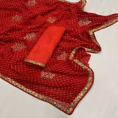 Red colored saree is prettified with beautiful printed with sequins embroidered lace border work as shown which makes it appear classy. This saree is made of georgette fabric which is accompanied with banglori silk blouse piece which you can customise as per your design/style. Women can buy this saree to wear for their festive and functions. Note:- The actual product may differ slightly in color and design from the one illustrated in the images when compared with computer or mobile screen. Measu Unstitched Red Sharara With Mirror Work, Red Chanderi Pre-draped Saree With Dupatta, Red Dola Silk Pre-draped Saree For Eid, Red Chinon Sets With Mirror Work, Festive Bandhani Print Georgette Pre-draped Saree, Red Saree Set With Mirror Work, Red Georgette Pre-draped Saree With Pallu, Red Chinon Sharara For Diwali, Red Chanderi Traditional Wear With Mirror Work