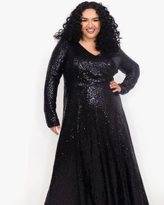 You will steal the spotlight at any formal occasion in this sleek long sleeve sequin formal gown. Finally, a fancy dress with the long sleeves you have been having trouble finding. Deep V-neckline and soft A-line skirt flatter your curves.  Soft, stretch knit lining guarantees you're comfortable all night long.  A must-have! Round out your vacation and weekend wardrobe with this plus size dress Celebrations by Sydney's Closet Uptown Evening Dress | Black | Dresses | Materials & Care Instructions Formal Sequined Maxi Dress For Fall, Fall Sequin Long Sleeve Maxi Dress, Winter Evening V-neck Dress, Long Sleeve Evening Dress For Gala In Winter, Long Sleeve Evening Dress For Winter Gala, Formal Long Sleeve Maxi Dress For Holidays, Formal Holiday Long Sleeve Maxi Dress, Long Sleeve Sequin Maxi Dress For Holidays, Holiday Formal Long Sleeve Maxi Dress