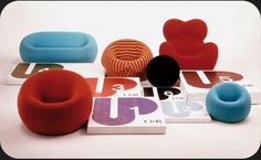 several different colored chairs and pillows on a white surface with the word up written in large letters