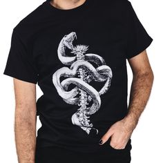 The men's black T-shirt is crafted with 100% premium cotton. our dark, detailed, eye-catching and sometimes controversial design is printed using (Direct-to-Garment) making your shirt a true work of art. With DTG printing, the ink is applied directly to the fabric, allowing for high quality and long lasting designs. Unisex Black T-shirt With Front Print, Artistic Black Short Sleeve T-shirt, Artistic Black Short Sleeve Shirt, Black Front Print Unisex T-shirt, Artistic Black T-shirt With Graphic Print, Artistic Screen Print Black Top, Artistic Black Top With Screen Print, Unisex Black T-shirt With Screen Print, Artistic Black Shirt With Graphic Print