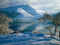 a poem written in front of a mountain lake with snow on the ground and trees