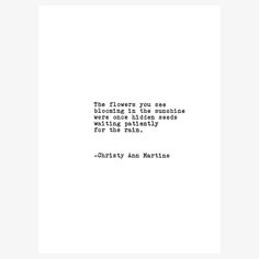 an old typewriter's quote on white paper with the words, the flowers you see blooming in the sunshine are waiting for the rain