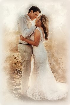 a bride and groom kissing in front of the ocean with their arms around each other