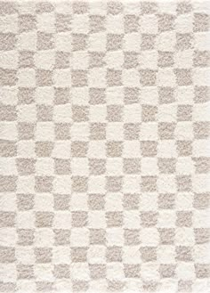 an area rug with squares on it in beige and white colors, made from thick wool