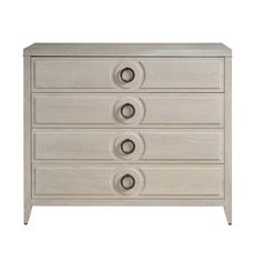 a white dresser with three drawers and four knobs