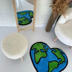 a heart shaped rug with the earth on it next to a chair and mirror in a room