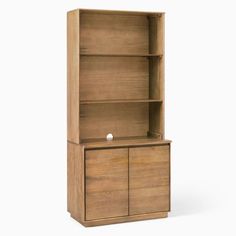 a wooden bookcase with two doors and one door open on the bottom shelf, in front of a white background