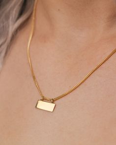 This is a gorgeous and trendy 14K gold engravable plate necklace. It is the perfect necklace to wear on its own or layered with some of your favorite pieces. This piece expertly combines classic and modern elements. The 14K yellow gold necklace features an engravable plate on an Open Curb Chain. NECKLACE DETAILS: Millimeter: 1.40 Chain Length:18 Inches Gauge: 040 Closure: Lobster Average Weight (g): 3.88 Available in: 14K yellow gold ****These necklaces have a 4-week lead time. If you need your Gold Rectangular Curb Chain Necklace, Rectangular Curb Chain Necklaces For Gift, Gold Nameplate Jewelry With Box Chain, Minimalist Yellow Gold Nameplate Jewelry, Rectangular Curb Chain Jewelry For Gift, Elegant Nameplate Box Chain Jewelry, Everyday Gold Nameplate Necklace, Gold Polished Dog Tag Jewelry, Elegant Gold Dog Tag Charm Necklace