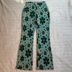 Flared Legging Type Pants With Flowers, It’s A Mainly A Turquoise Blue Color Trendy Floral Print Bottoms For Loungewear, Trendy Long Bottoms With Floral Print, Trendy Long Pants With Floral Print, Trendy Long Floral Print Bottoms, Fitted Flare Bottoms In Green, Green Fitted Flare Bottoms, Retro High Waist Floral Print Pants, Fitted Flare Green Bottoms, Retro High Waist Floral Pants