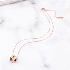 Add an instant splash of glam to your everyday ensembles wearing this geometric piece cast in gleaming 18k rose gold-plated metal. Chain: 15.8'' L with 2'' extender Pendant: 0.43'' W x 0.43'' H Lobster claw clasp 18k rose gold-plated titanium steel / cubic zirconia Chic Rose Gold Clavicle Chain Jewelry, Modern Rose Gold Cubic Zirconia Jewelry, Modern Rose Gold Jewelry With Cubic Zirconia, Elegant Rose Gold Plated Necklace, Chic Rose Gold Jewelry With Clavicle Chain, Rose Gold Square Pendant Necklace For Anniversary, Minimalist Rose Gold Jewelry For Party, Rose Gold Metal Necklace For Anniversary, Rose Gold Metal Necklaces For Anniversary