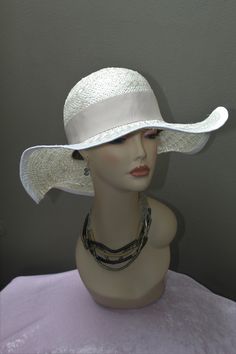 Hand made women's Sisal Sun hat by Alexander & Hallatt in white with beige band. Great feel and movement of pure sisal. Crown is stiffened. Please note that Alexander & Hallatt strive to produce the highest quality hats with minimal synthetic materials (synthetics used in mass produced hats flooding the market). With care, this hat can last a long time. Also note that there will be imperfections, like a stich showing or a line which is not perfect, but this adds to the charm of a true one-of a k Elegant Short Brim Hat With Uv Protection, Elegant Brimmed Hat With Uv Protection, Elegant Adjustable Straw Hat With Upf 50+, White Panama Hat With Curved Brim, White Panama Hat With Flat Brim For The Beach, White Panama Hat With Flat Brim For Beach, White Panama Hat For Beach With Flat Brim, Elegant Brimmed Sun Hat With Uv Protection, Elegant Adjustable Straw Hat With Uv Protection